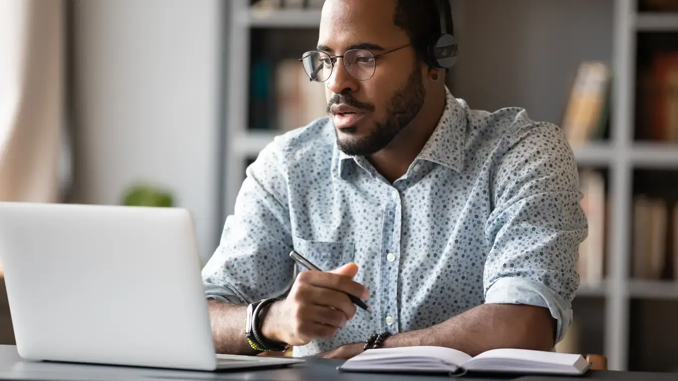 Man watching webinar on laptop